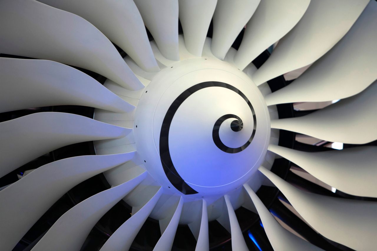 High-resolution image of a jet engine turbine blade, showcasing intricate details and curvature.