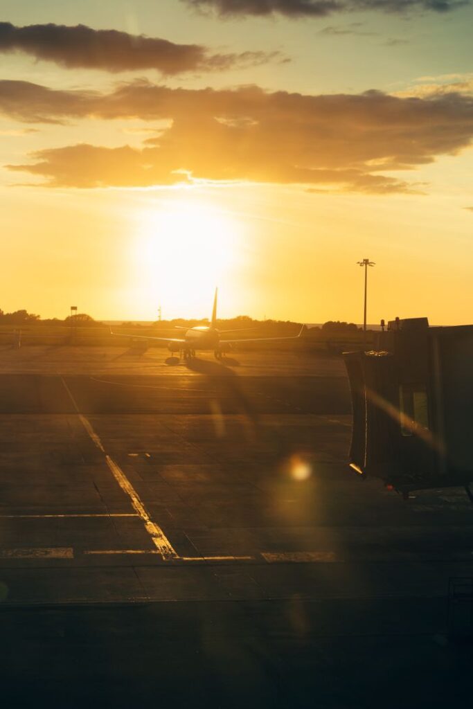 A stunning sunset view of an airplane on the runway at Kota Kinabalu Airport, Sabah, Malaysia.